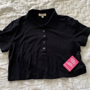 A black collared shirt.The size is a junior medium. The brand is heart and hips.